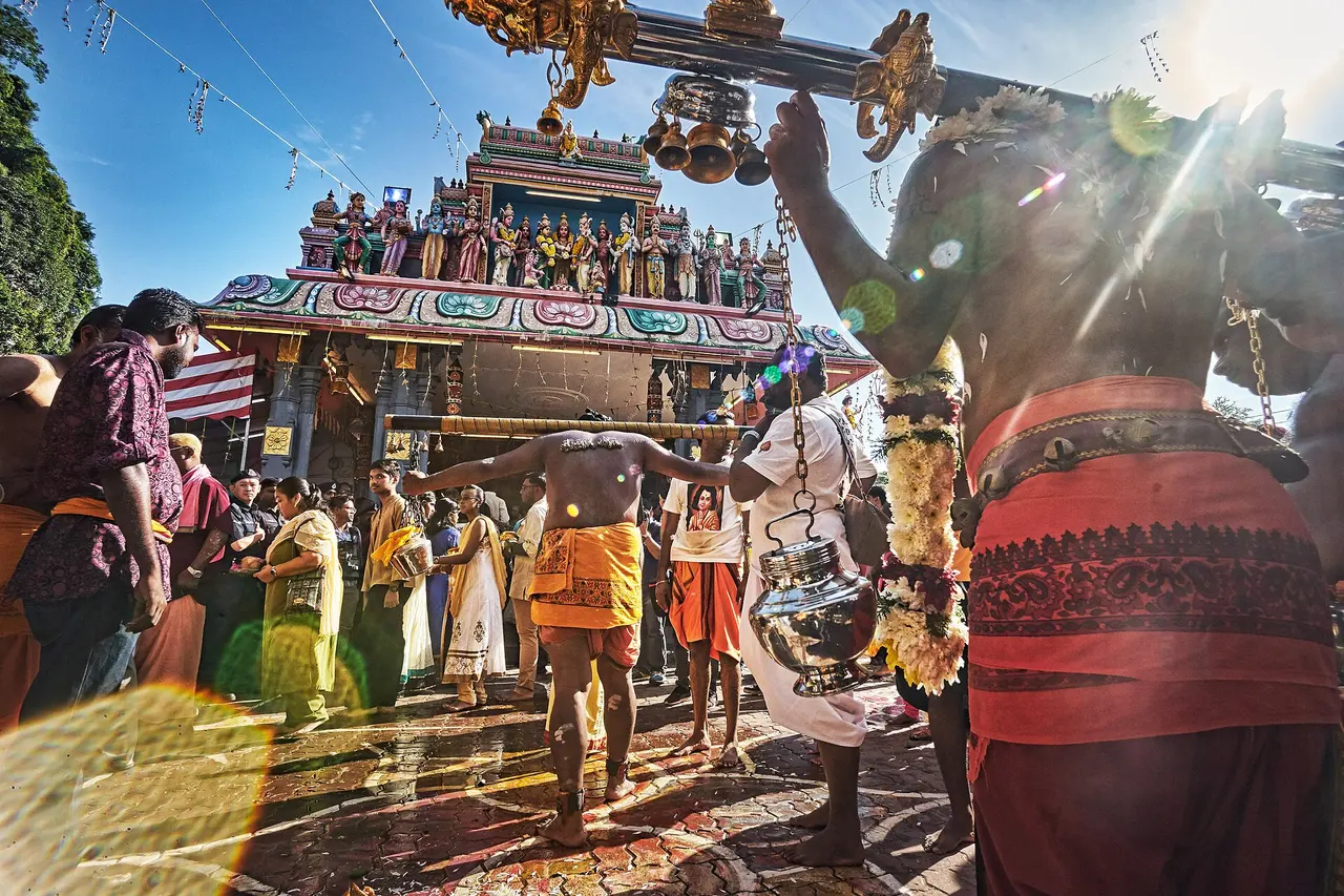 Devotees and a decorated chariot at Thaipusam in Ipoh